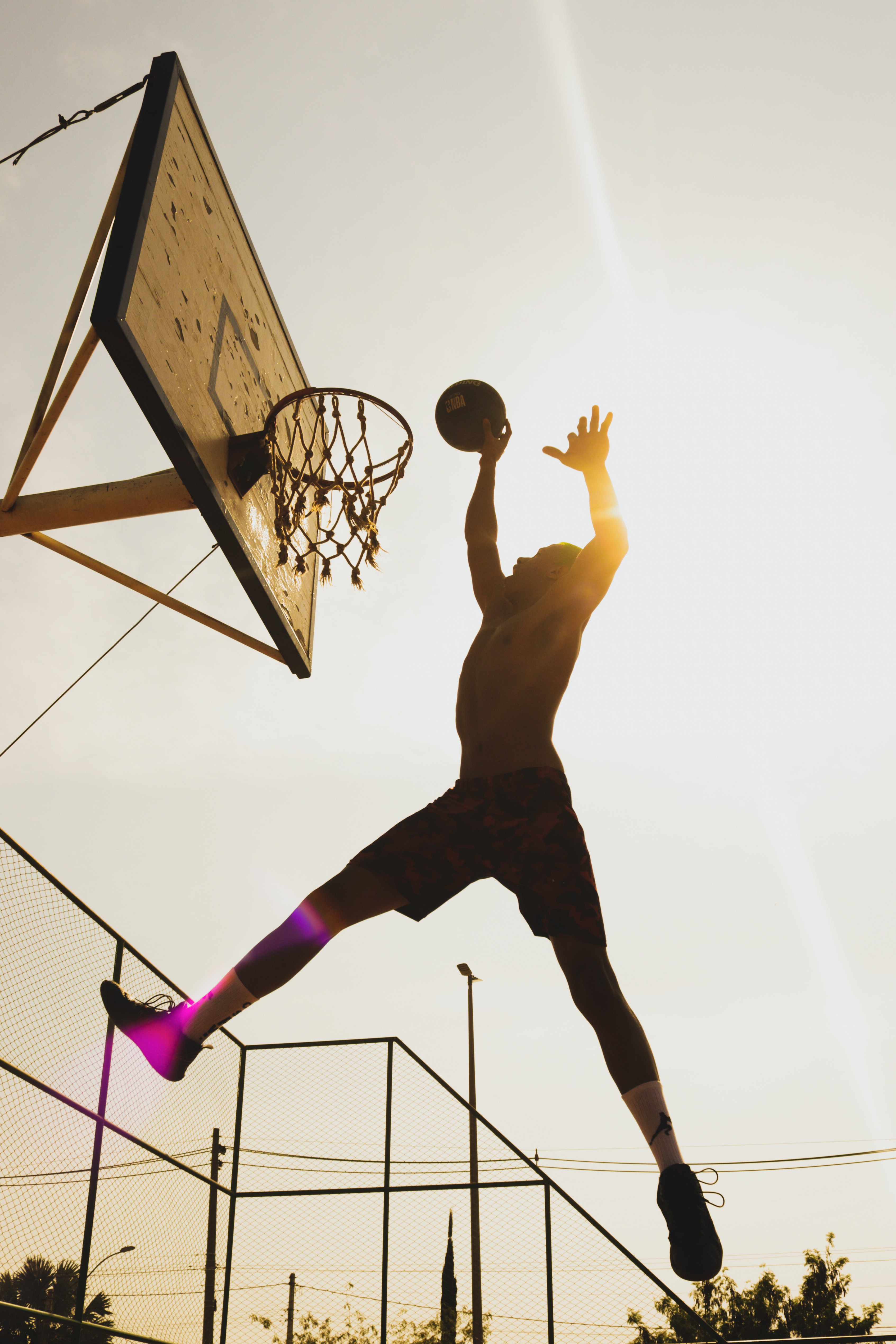 A person dunking a basketball